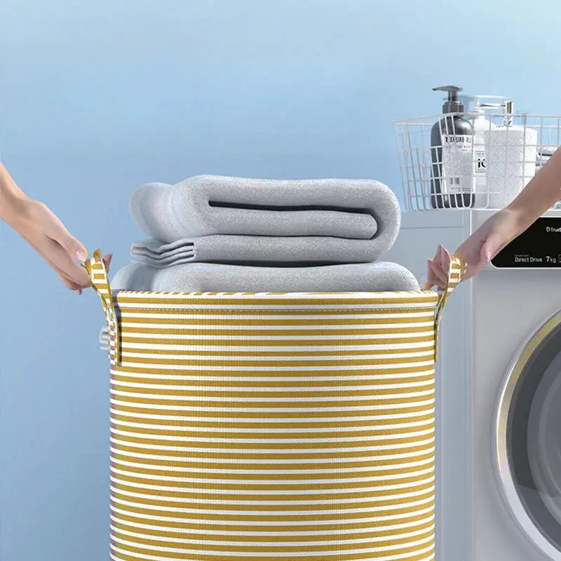 Foldable minimalist striped laundry basket by Simples Market; yellow and white stripes, collapsible storage