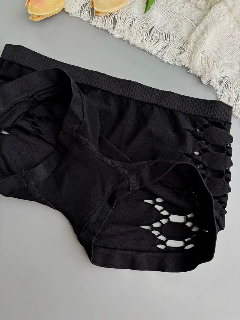Black seamless athletic shorts with side mesh hollow-out cutouts