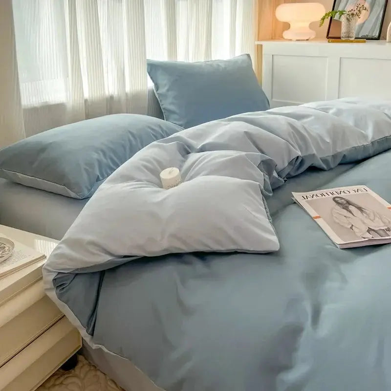 Simples Market 4-piece light blue duvet cover bedding set with pillowcases on a made bed.