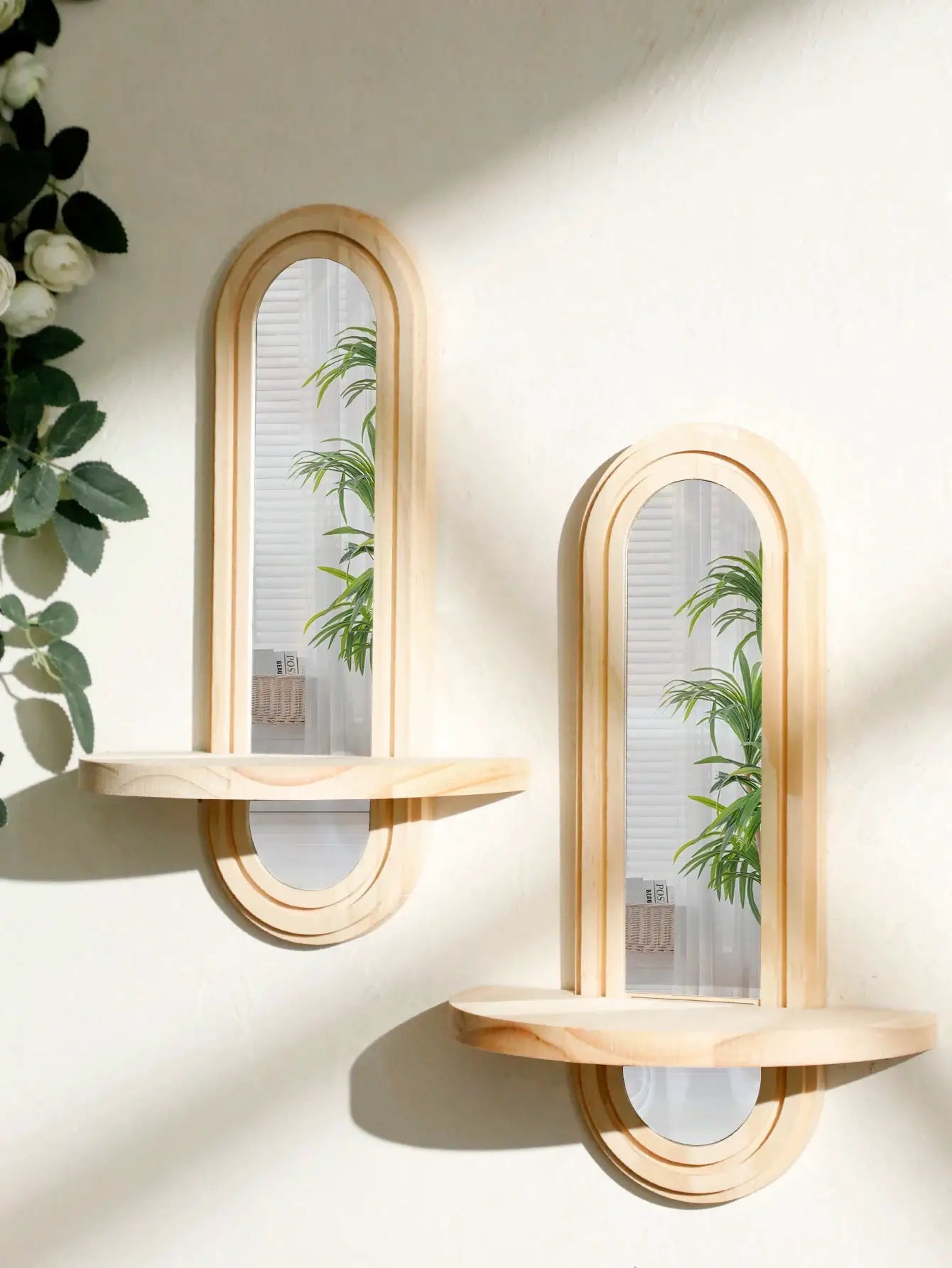 Two boho-style arched wooden wall shelves with mirrored panels in natural finish by Simples Market
