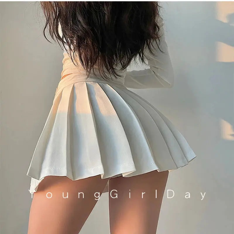 White pleated high-waist mini skirt with A-line silhouette.