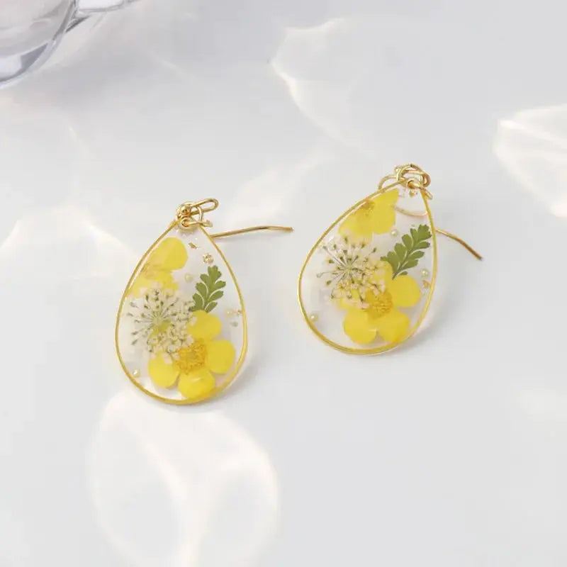 Colorful natural flower earrings in gold-edged epoxy resin teardrops with yellow blooms, Simples Market (pair)