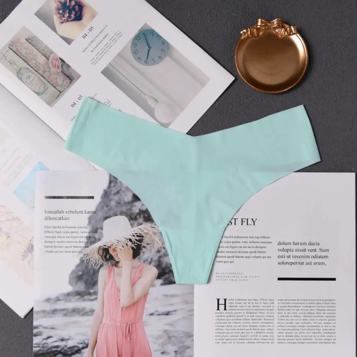 Light blue seamless thong underwear for women displayed on magazines
