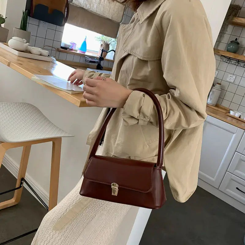 Shoulder bag brown leather with front flap and gold-tone clasp, retro style