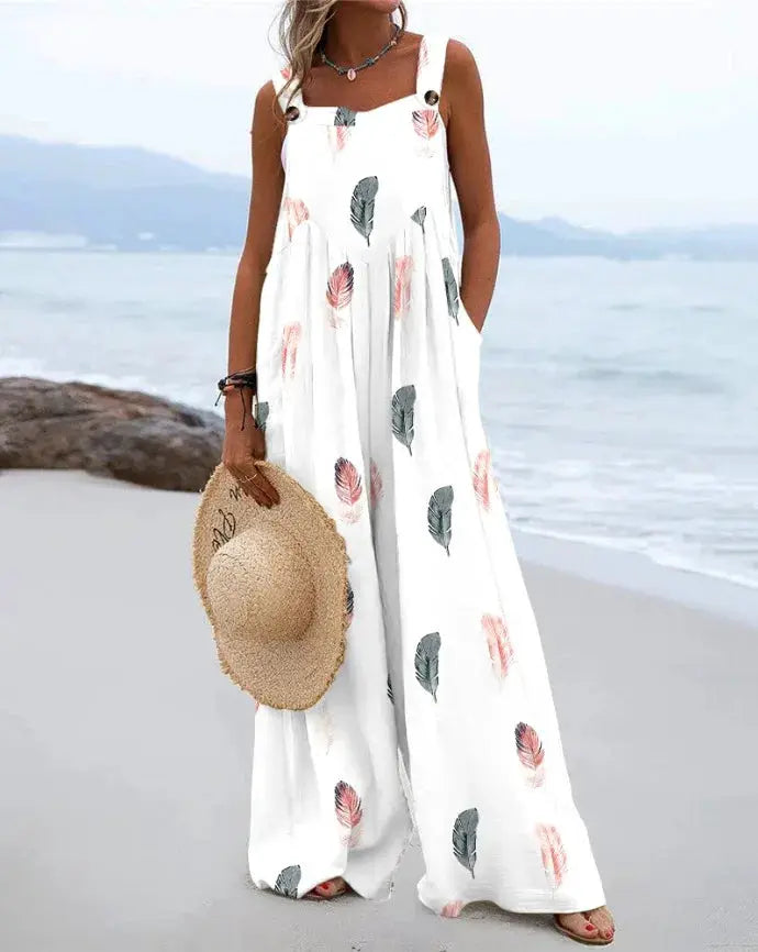 Women's sleeveless jumpsuit by Simples Market, white with feather prints and buttoned straps, wide-leg beachwear.