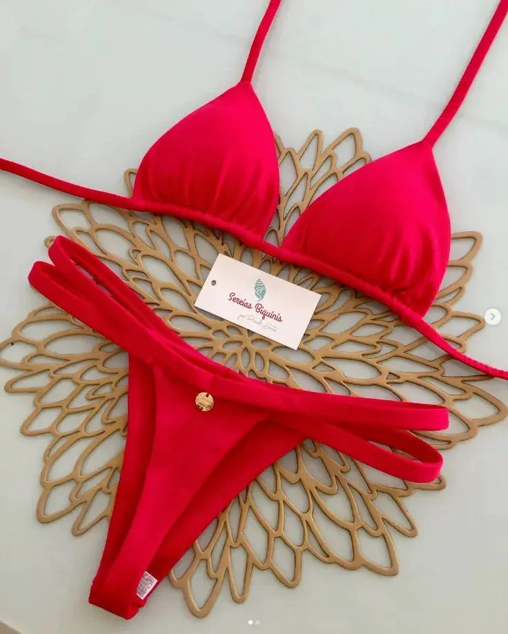 Red halter bikini set with thong bottoms and a gold coin charm on the front