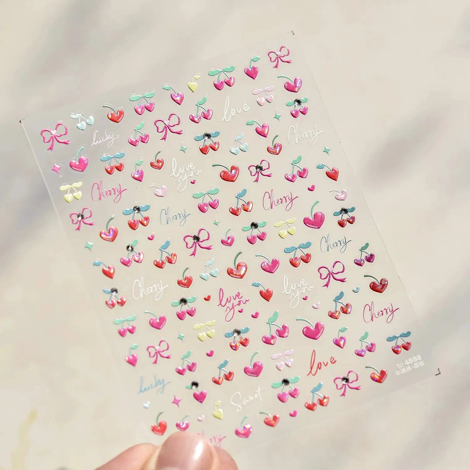 Self-adhesive nail art stickers sheet with pink translucent cherries, bows and hearts in pastel 3D finish
