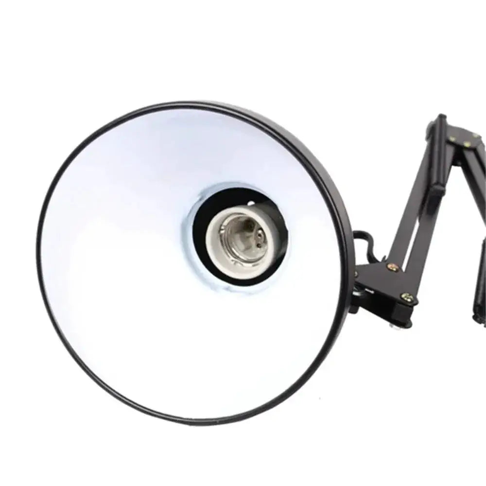 Swing-arm clamp lamp by Simples Market with black adjustable arm and reflective metal shade
