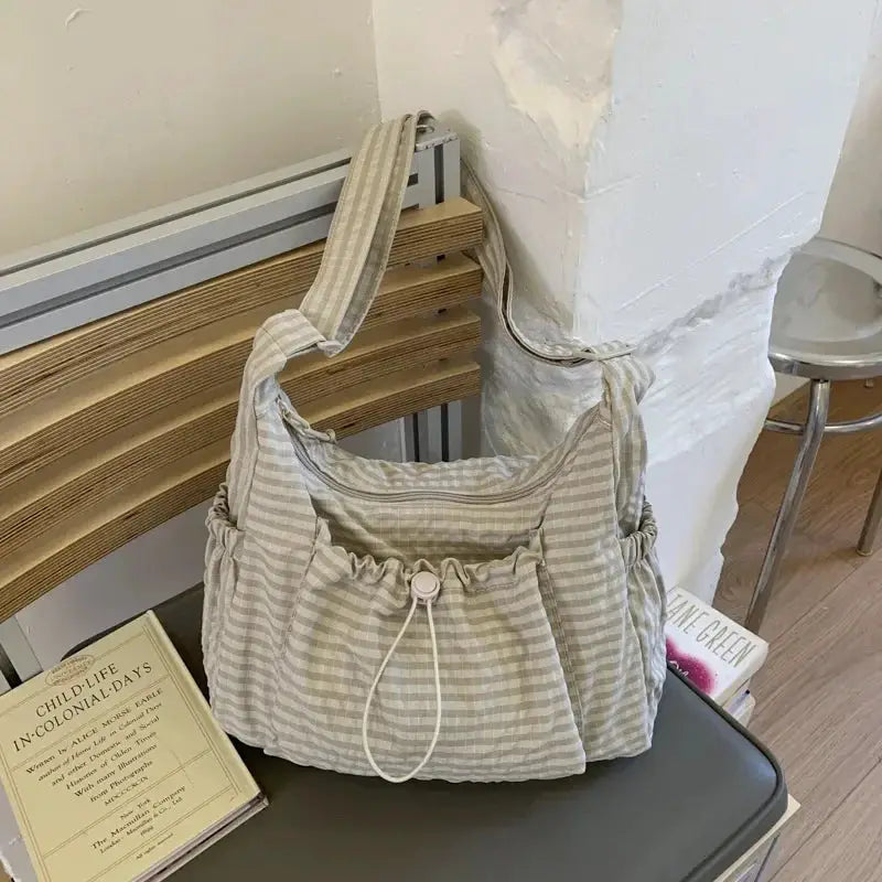 Simples Market Korean nylon shoulder bag in beige plaid with drawstring closure and pleated silhouette