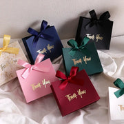 Ten mini gift boxes by Simples Market in assorted colors with gold Thank You text and satin ribbons.