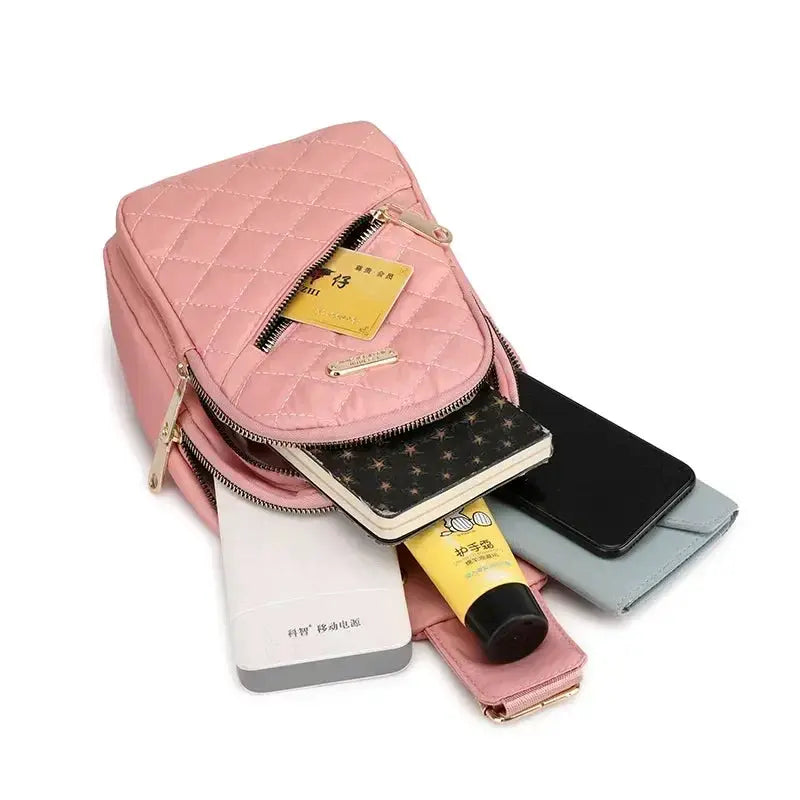 Pink quilted shoulder bag backpack by Simples Market with gold zippers