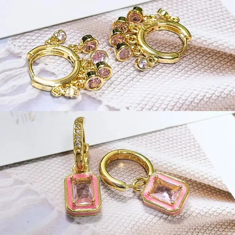 Pair of gold-tone hoop earrings with pink square zircon pendants, geometric design.