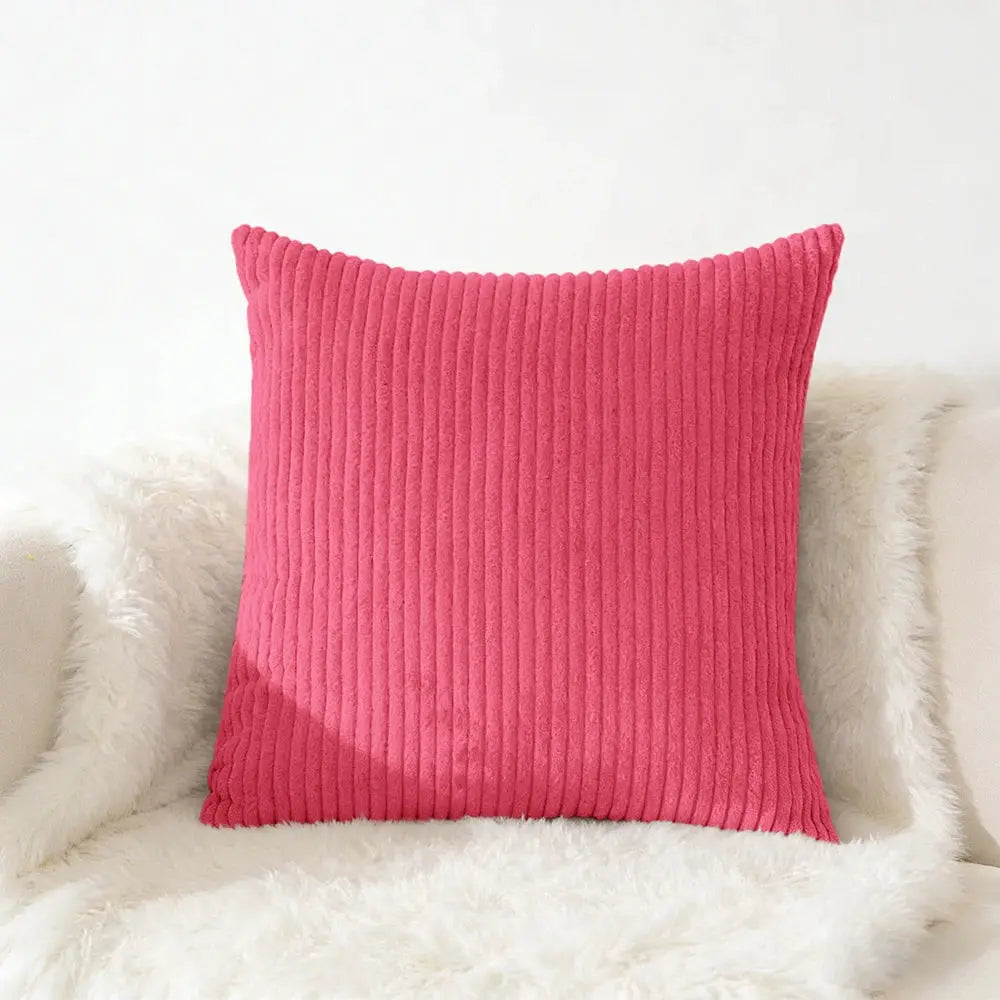 Pink corduroy pillow cover with ribbed texture for sofa or living room.