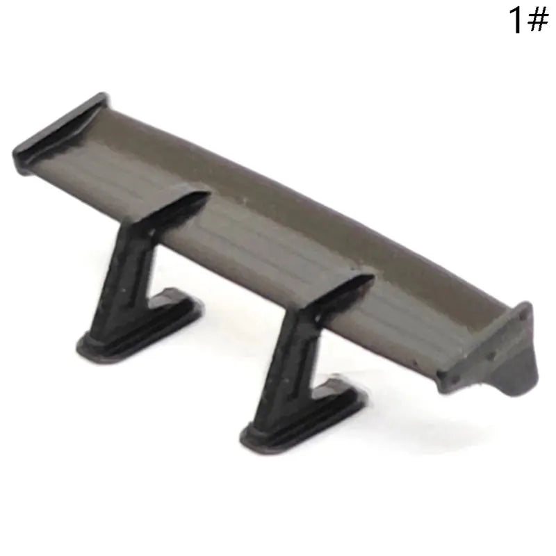1:64 scale model car rear spoiler wing in dark gray plastic with black supports