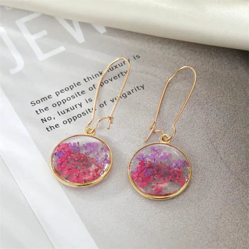 Natural flower dangle earrings, round epoxy resin drops with pink-purple pressed flowers, pair, gold-tone metal