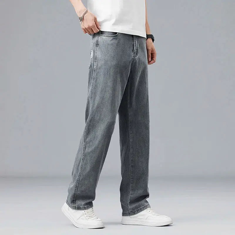 Men's loose straight gray denim jeans with relaxed drape.