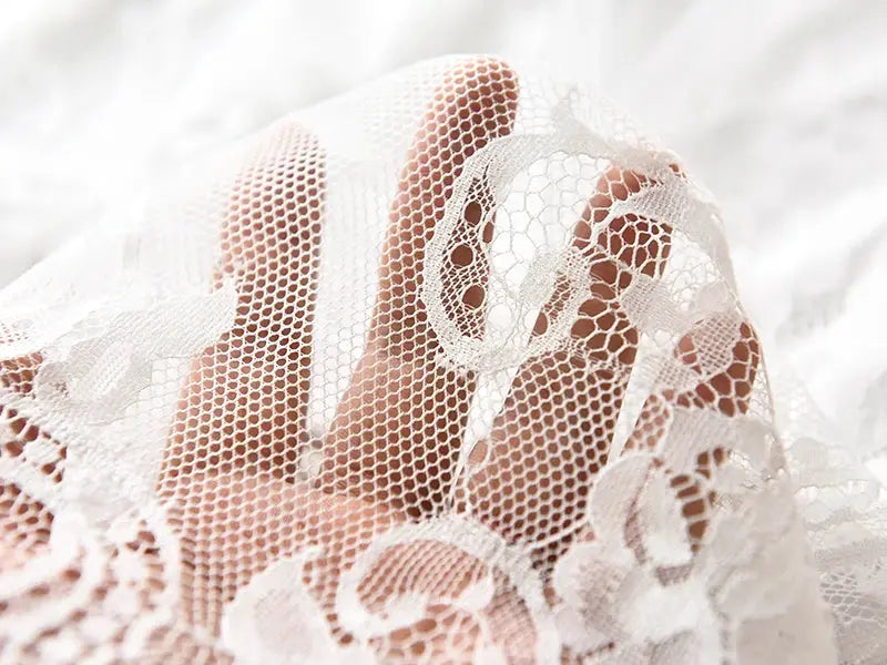 White lace long skirt close-up with sheer floral mesh fabric