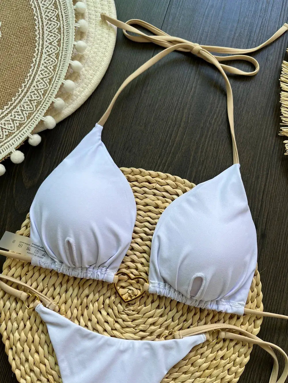 White RUOTONSEPT halter bikini set with triangle top and string-tie bottoms on a woven straw bag