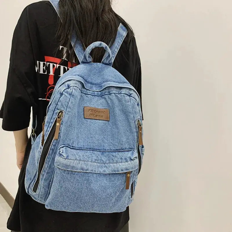 Simples Market denim backpack for school with multiple pockets and brown zipper pulls, large capacity
