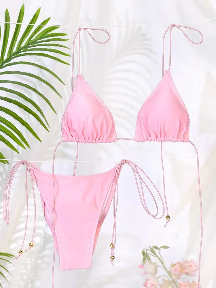 Pink bikini set with triangle top and string-tie bottoms, bead-tipped ends.