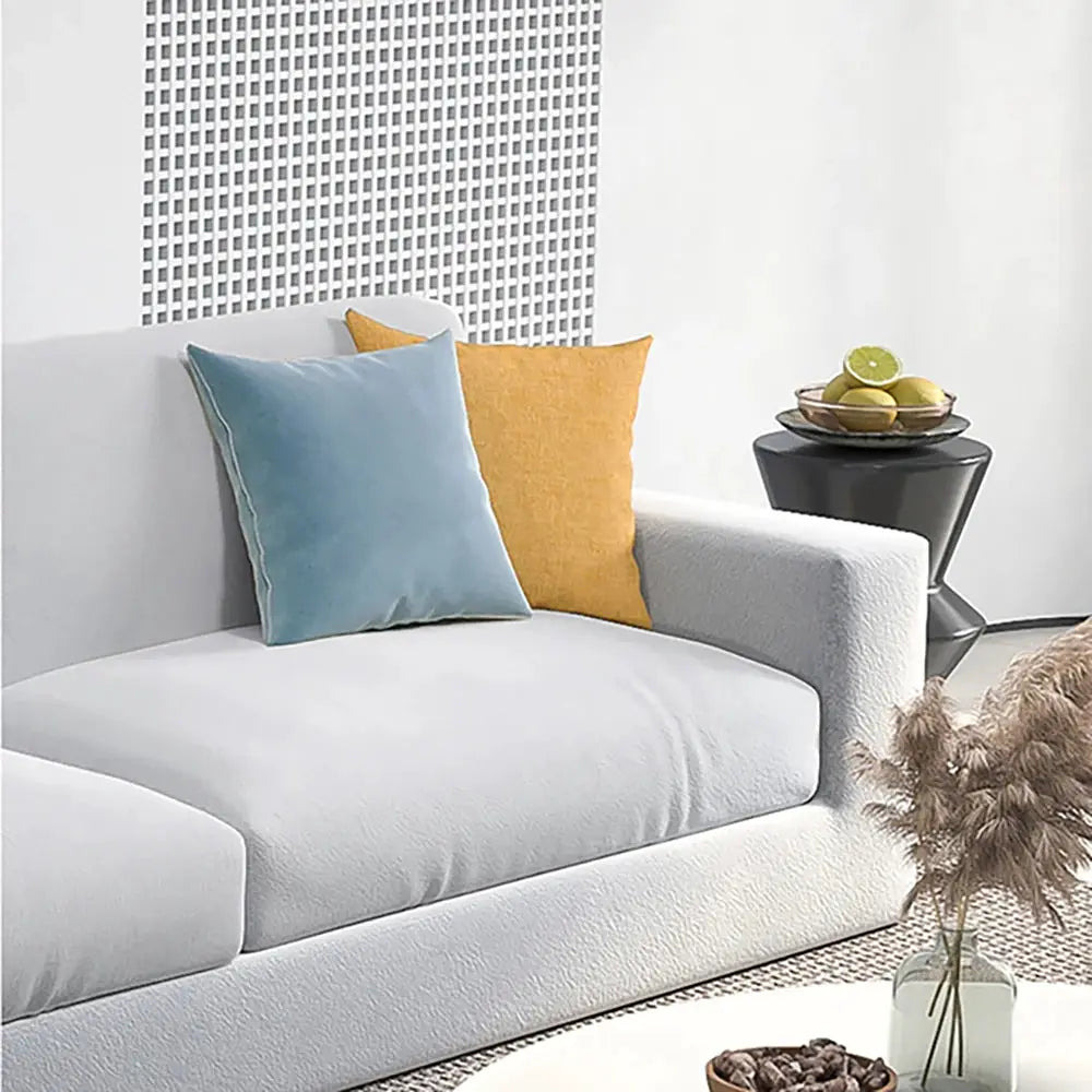 Velvet sofa cushion covers set in blue and orange for an L-shaped sectional couch
