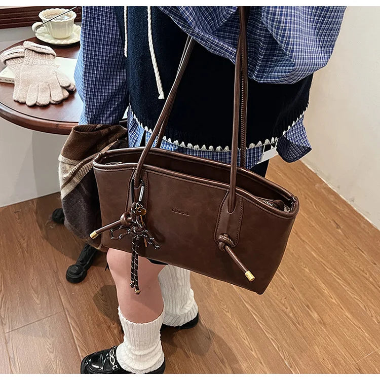 Brown PU leather shoulder bag for women with long straps and tassel charm