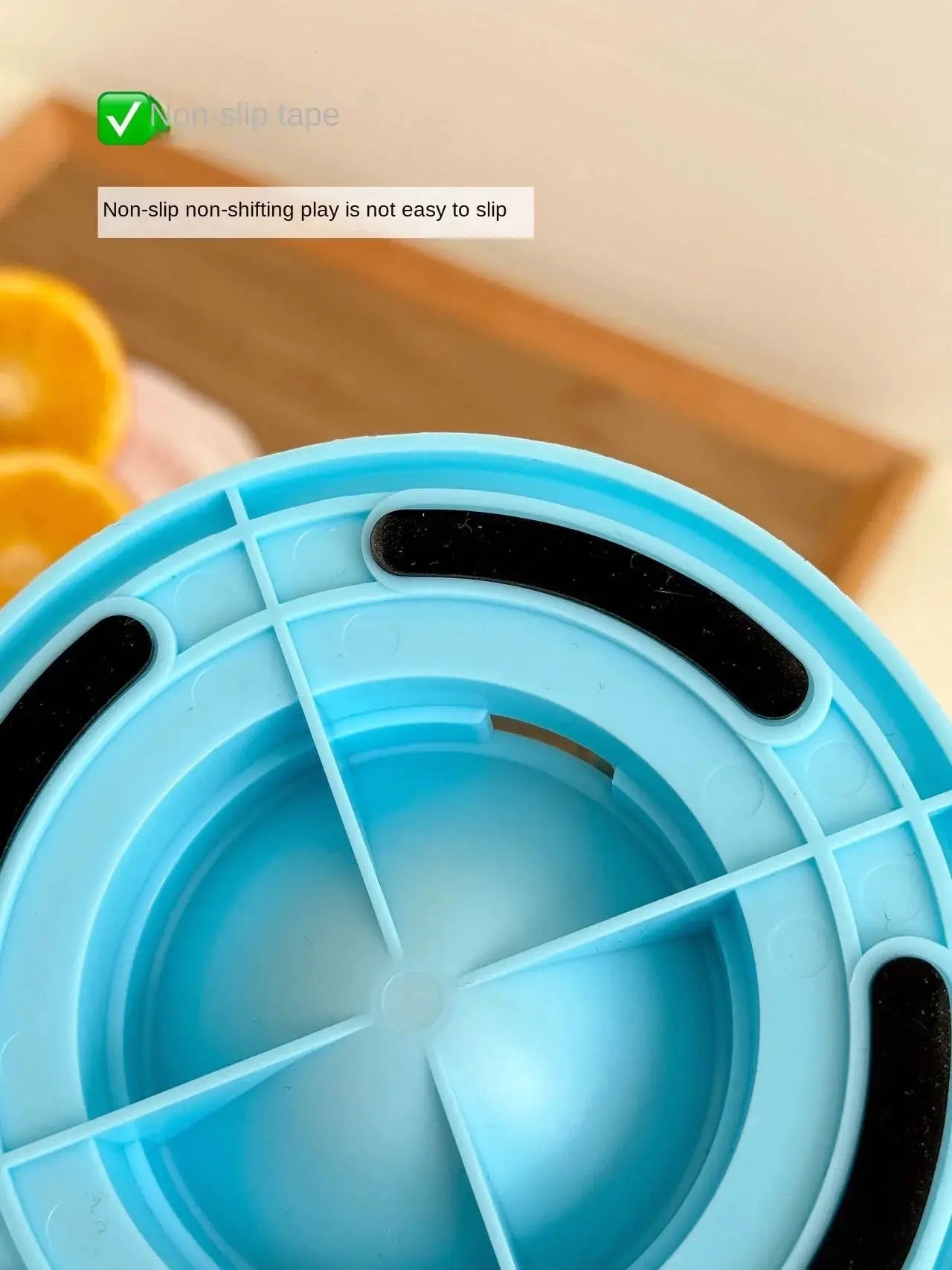 Blue plastic interactive dog toy slow-feeder with compartments and black non-slip grip strips