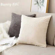Corduroy striped cushion covers in beige and gray; two cushions on a sofa, Simples Market.
