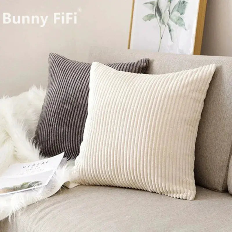Corduroy striped cushion covers in beige and gray; two cushions on a sofa, Simples Market.