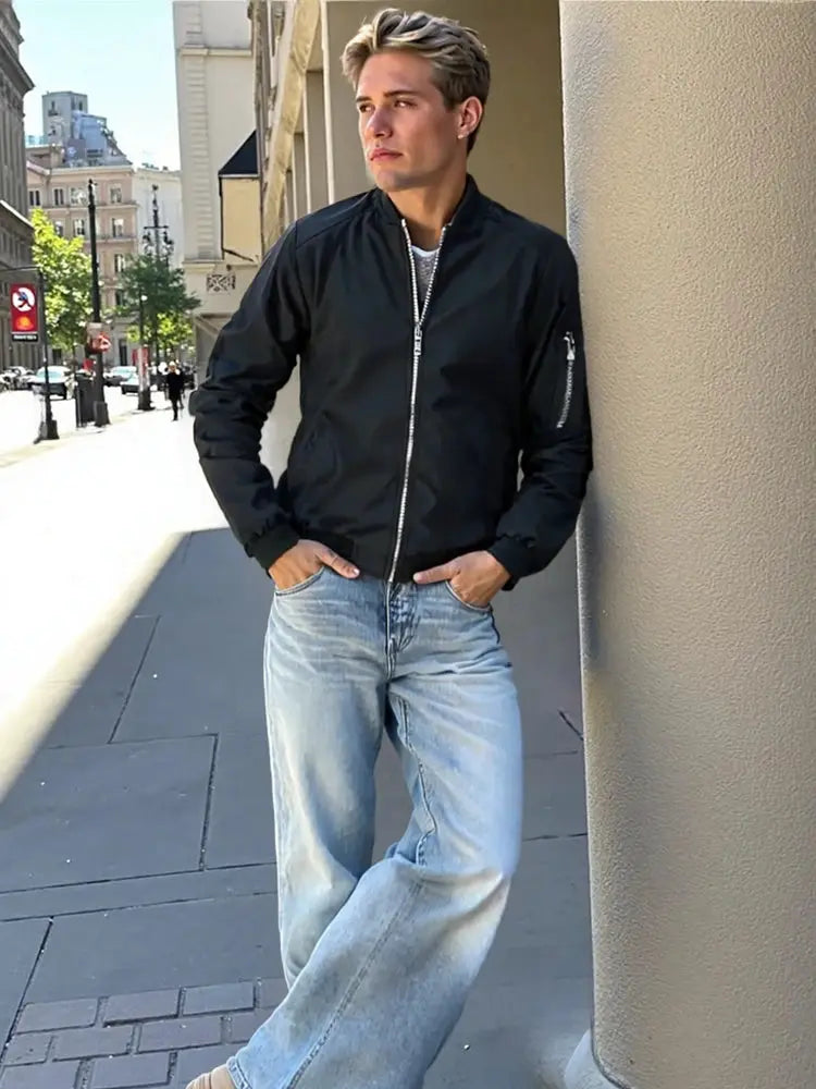 Men's black windbreaker jacket with silver front zipper and zip pockets, lightweight casual coat