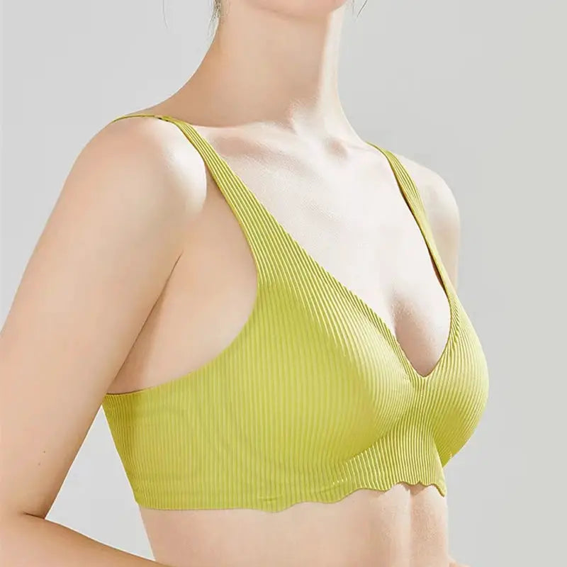 Seamless women's bra lime-green striped bralette with thin straps on a model