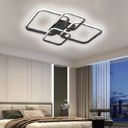 Modern LED ceiling light with four interlocking square heads in black and white, by Simples Market.