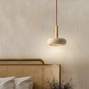 Circular stone LED pendant lamp with wood stem and warm yellow glow for home decor.