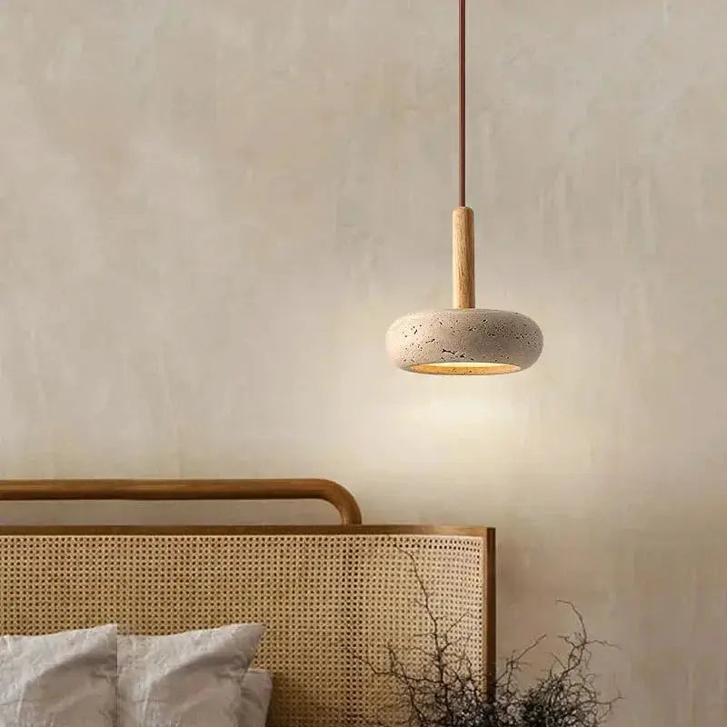 Circular stone LED pendant lamp with wood stem and warm yellow glow for home decor.