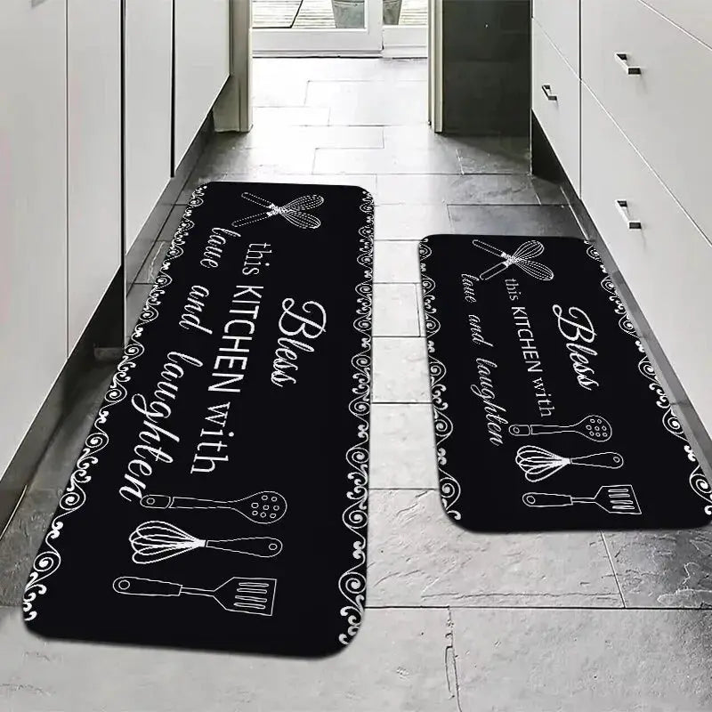 Two black kitchen sponge water-absorption anti-slip mats with white utensil illustrations and decorative border