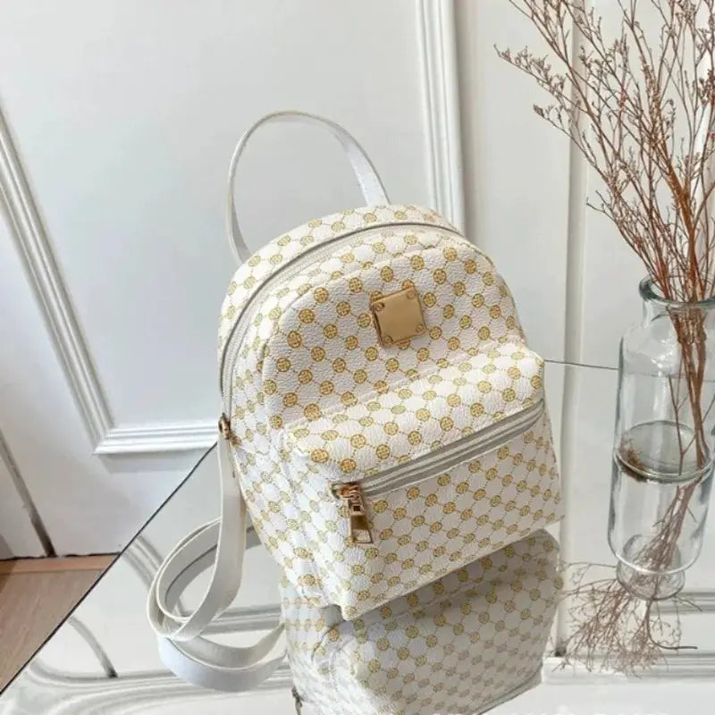 Backpack for women, white polka-dot pattern with gold accents by Simples Market, front zip pocket