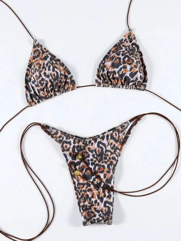 Leopard print bikini set with triangle top and high-cut thong bottom, brown string ties and gold button accents.