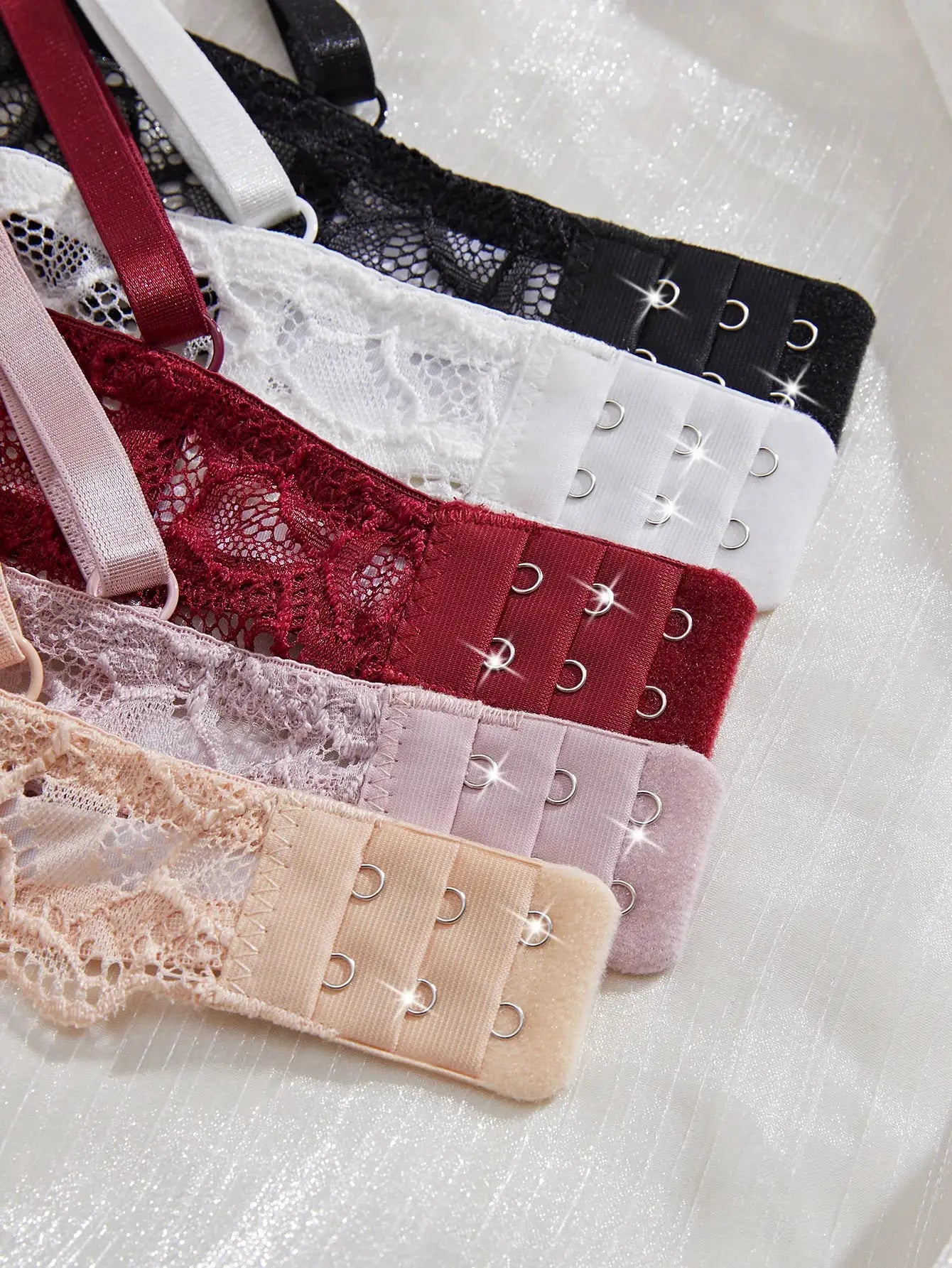 Set of lace bras in assorted colors with hook closures and underwire cups