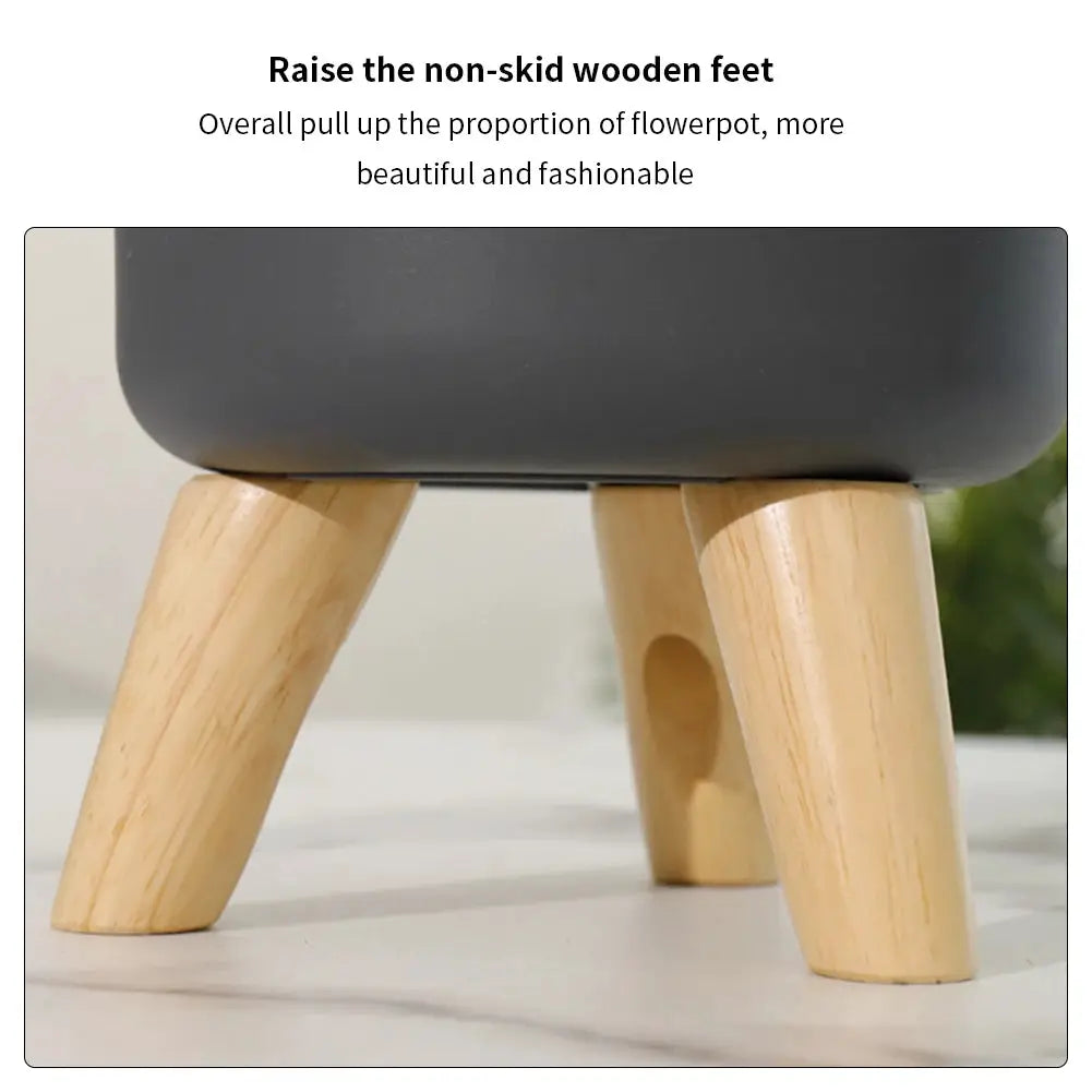 Floor-standing round flower pot on natural wood legs, gray planter