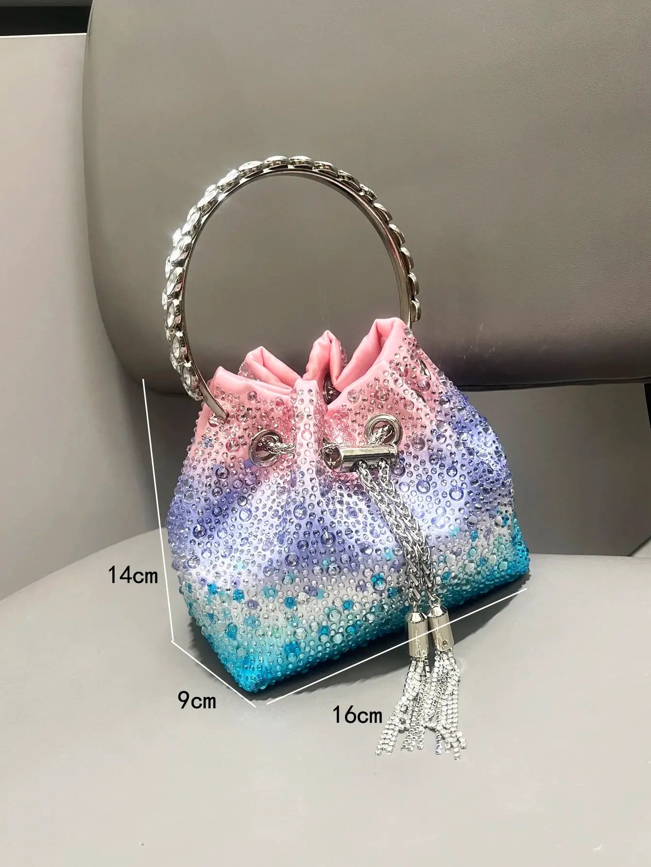 Evening rhinestone clutch by Simples Market with gradient pink-to-teal body and crystal ring handle