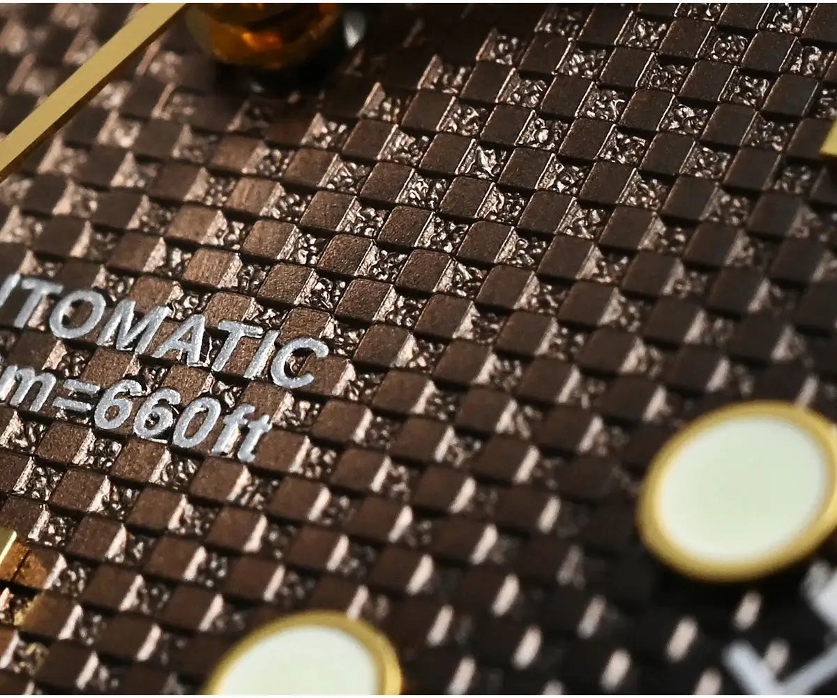 Automatic diver watch backplate close-up with carbon-fiber texture and gold-edged circular accents