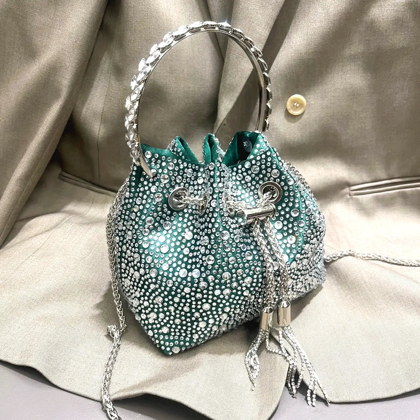 Rhinestone evening clutch bag with teal body, crystal-dotted surface and crystal hoop handle