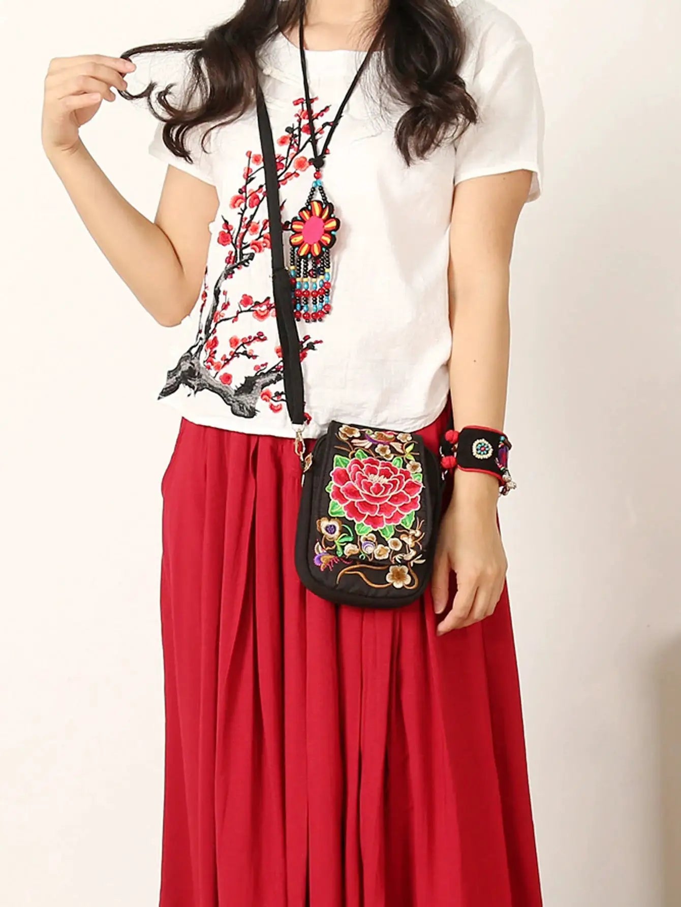 Crossbody phone bag with zipper, black canvas, colorful floral embroidery