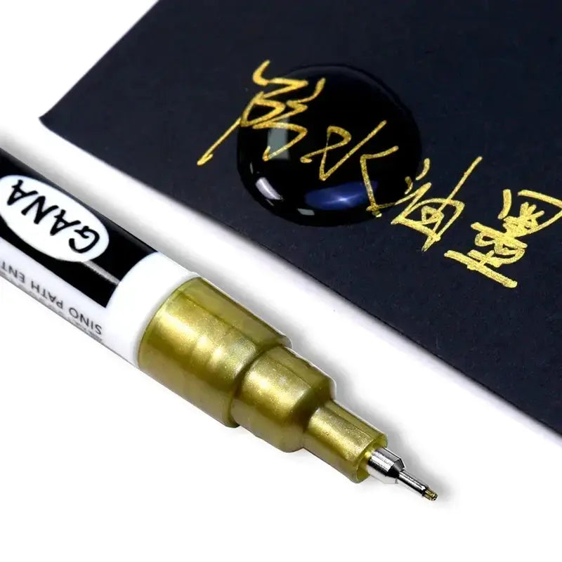 GANA oil-based white/black permanent paint marker, 0.7mm extra-fine tip, white body with gold nib
