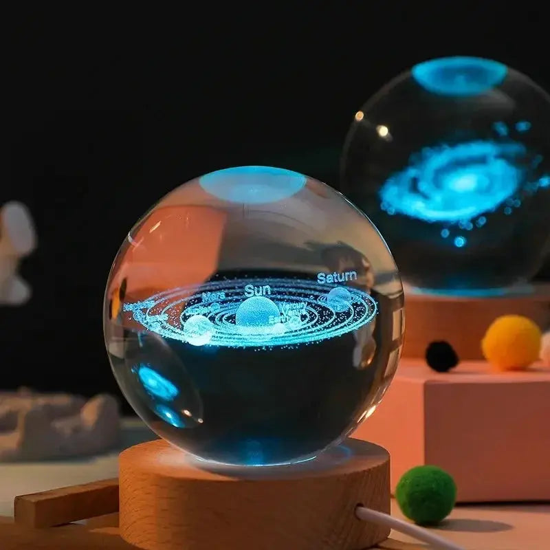 Crystal ball night light with blue laser-engraved solar system map on wooden base by Simples Market