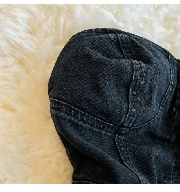Denim romper close-up in dark wash; casual wide-leg jumpsuit silhouette