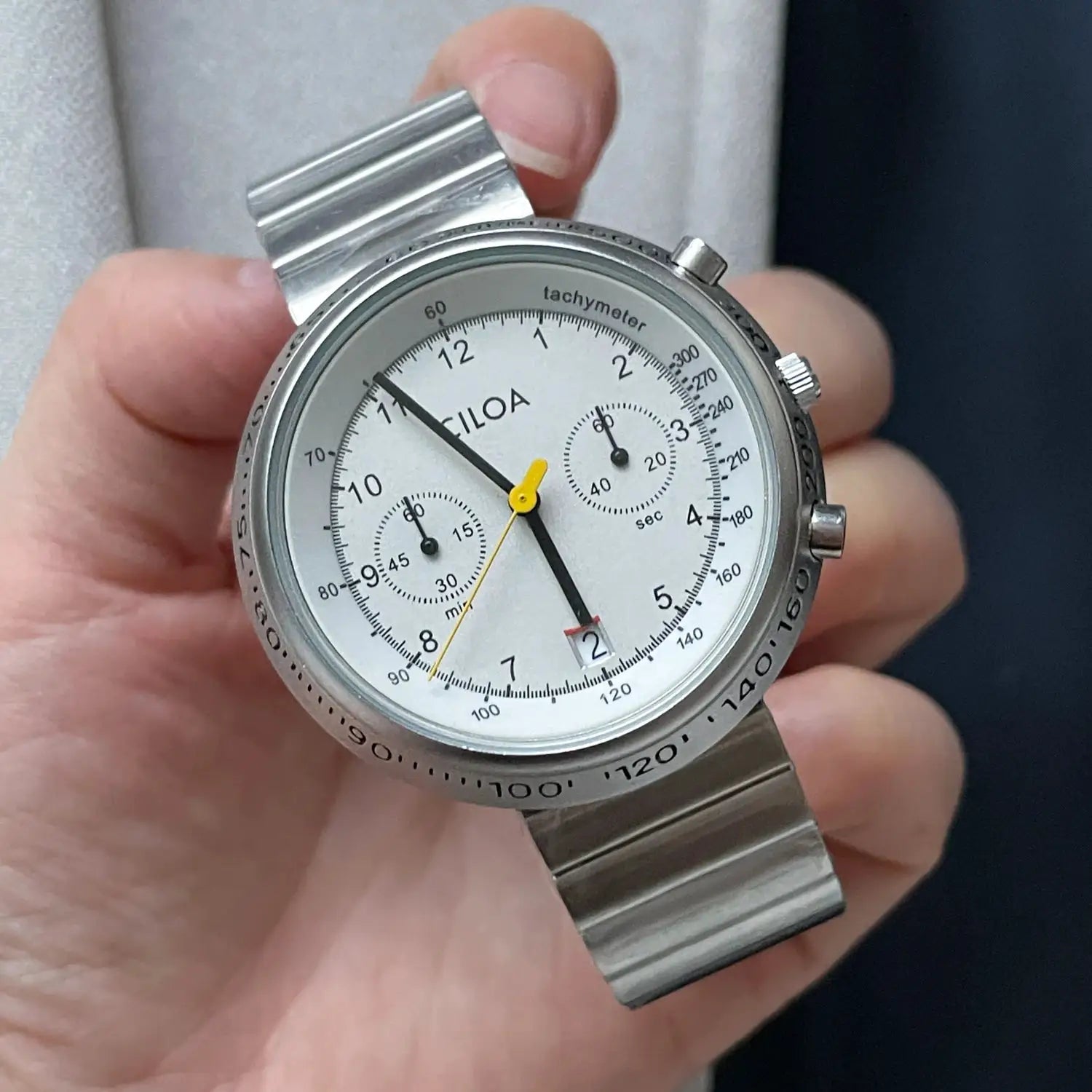 CILOA men's chronograph watch; silver-tone stainless steel bracelet, white dial with tachymeter bezel