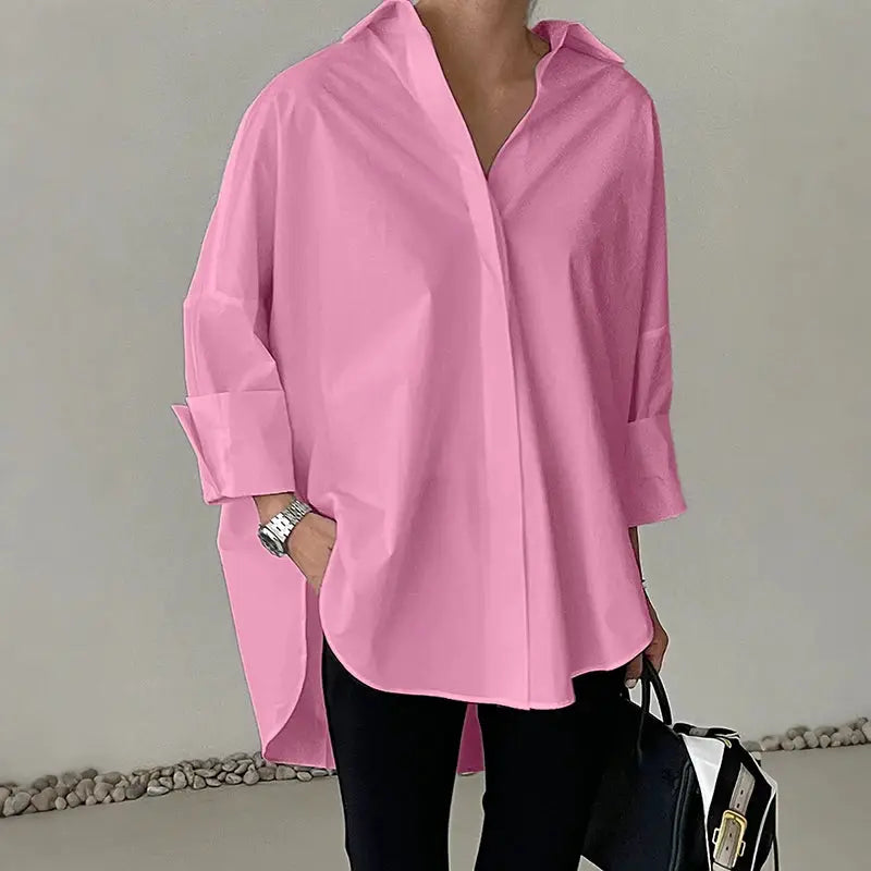 Oversized pink shirt blouse with turn-down collar, long sleeves, and high-low hem; button-up style