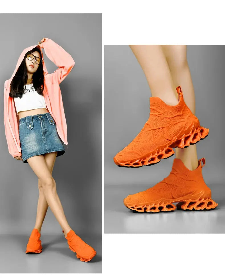 Sneakers in orange with sock-style knit upper and sculpted hollow sole; model shown wearing with a denim skirt.