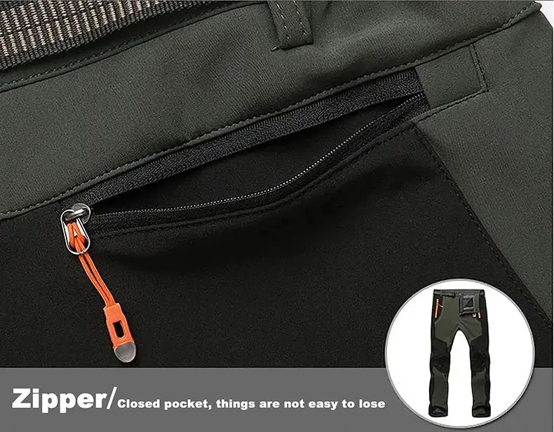 Men's hiking pants with dark olive-green and black panels, orange zipper pull, zippered pocket